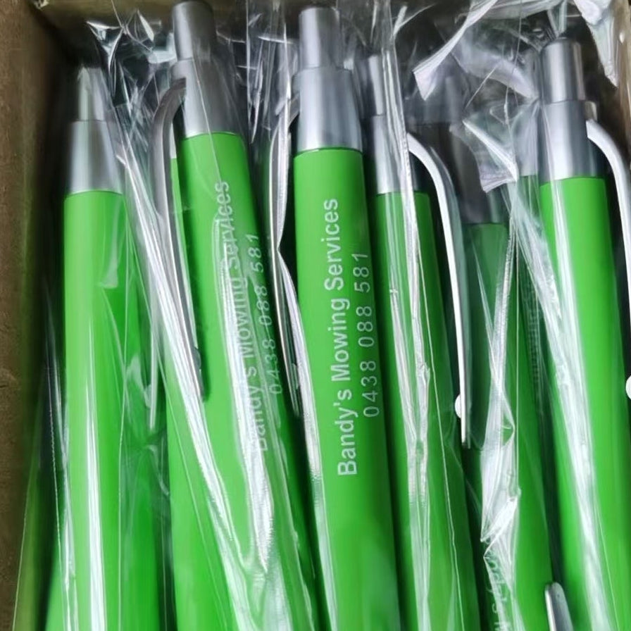 Box of green and silver pens with 'Bandy's Mowing Services' branding.